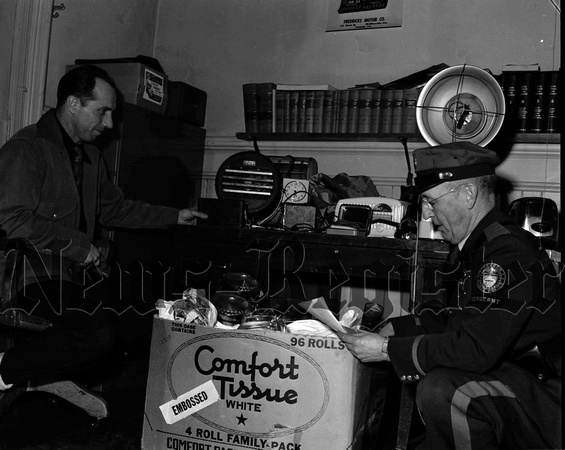 1950-1-26 Police looking over stolen goods by Ralph Kenny.jpeg