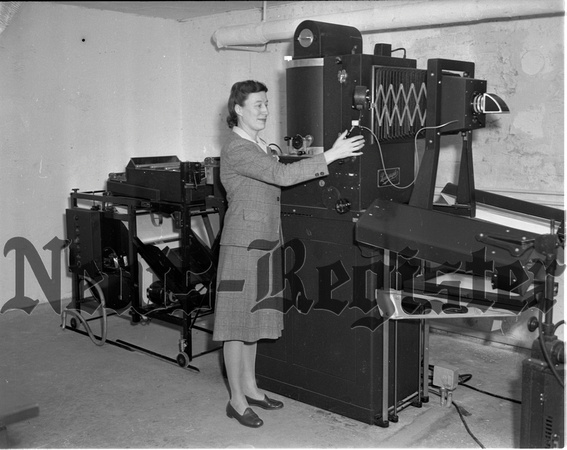1945-1-25 Mrs. Lou Saylor with new County Photo Machine 1.jpeg