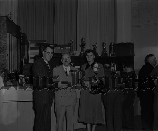 1951-12 Pacific Coast Turkey Exhibit-Bus and Margaret Hadley of Dayton reciving trophy from Dan O. Smith.jpeg