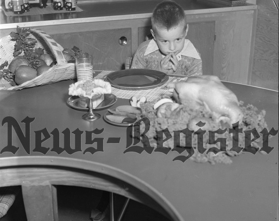 1951-11 Thanksgiving grace at table by little Powell boy 1.jpeg
