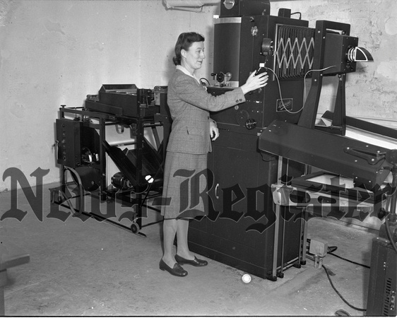 1945-1-25 Mrs. Lou Saylor with new County Photo Machine.jpeg