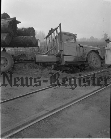 1955-3-25 Log truck Loses in Duel with train Extra 2.jpeg
