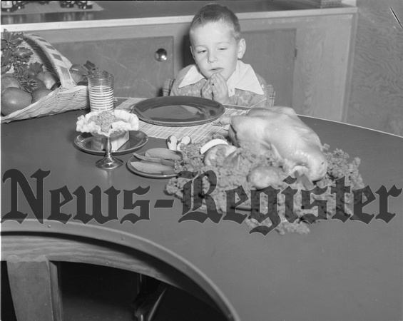 1951-11 Thanksgiving grace at table by little Powell boy.jpeg