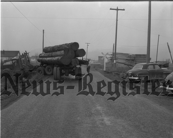 1955-3-25 Log truck Loses in Duel with train Extra 1.jpeg